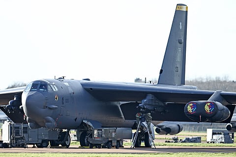 USAF military personnel work on US Air Force B-52 Stratofortress bomber, on the tarmac at RAF Fairford in south-west England on March 13, 2026. Fairford is one of two bases, along with the Diego Garcia facility in the Indian Ocean, that the UK has given the US permission to use for "specific defensive operations into Iran" to destroy Iranian missiles at source, the British defence minister said in a statement.
