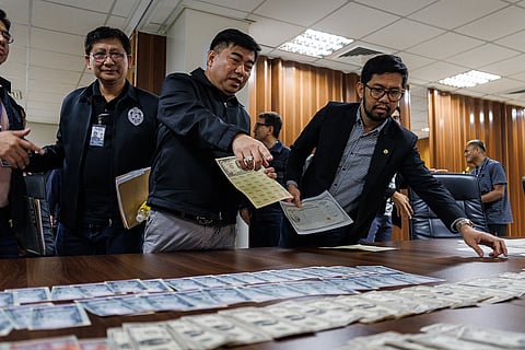 National Bureau of Investigation Director Atty. Melvin Matibag and Bangko Sentral ng Pilipinas representative Atty. Mark Fajardo inspect the alleged counterfeit foreign banknotes and U.S. Treasury bills seized in a buy-bust operation during a press conference in Pasay City on Friday, 13 March 2026.

The suspect was arrested after a three-month investigation by the NBI Criminal Intelligence Division, with authorities recovering alleged fake U.S. dollar banknotes and other foreign currencies valued at about 12 billion pesos.

“Sa Amerika, ayan po ay accepted. Dito sa atin, hindi. I don’t know why?” the suspect said.