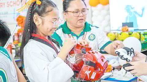 A TAEKWONDO jin of RAES receives training gears from ICTSI Foundation. 