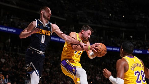 Luka Doncic #77 of the Los Angeles Lakers grabs the rebound during the game against the Denver Nuggets on March 5, 2026 at Ball Arena in Denver, Colorado.