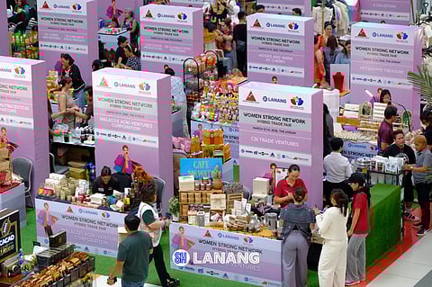 SHOPPERS browse booths from women-led MSMEs during the Women Strong Network Hybrid Trade Fair at SM Lanang, organized by WomenBizPH in celebration of Women's Month. The event features 30 exhibitors showcasing products and innovations from women entrepreneurs.