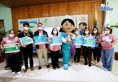 A mascot named Nurse Susie with Healthcare workers hold a placard calling for the promotion of Toxics-Free Hospitals during a Women’s Month Program at Quirino Memorial Medical Center in Quezon City on Tuesday, March 17, 2026. Campaigners led by BAN Toxics, call for proper healthcare waste management as a way to reduce the release of toxic and hazardous chemicals for a much safer environment for patients, healthcare workers, waste workers, and the public. Photo/Analy Labor