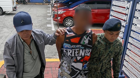 AUTHORITIES escort the motorcycle driver who was allegedly involved in the shooting of Manila Mayor Francisco ‘Isko Moreno’ Domagoso’s security to the Manila Police District Homicide Division on Tuesday. 