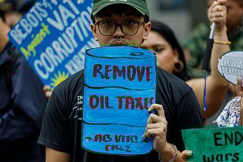 Student activists stage a protest in front of a gas station in Manila, demanding the government to remove oil excise and VAT taxes amid the rising fuel prices caused by the escalating conflict in the Middle East, on Tuesday, 17 March 2026.
