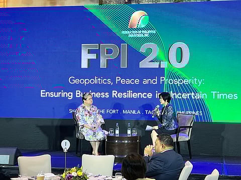 FPI president Elizabeth Lee (seated right) said FPI member companies expected the peso’s hitting P60 because of the tension in the MidEast, With her onstage at a FPI forum at the Shangri-la The Fort in Taguig City on 19 March is  DFA Secretary Ma. Theresa P. Lazaro. 