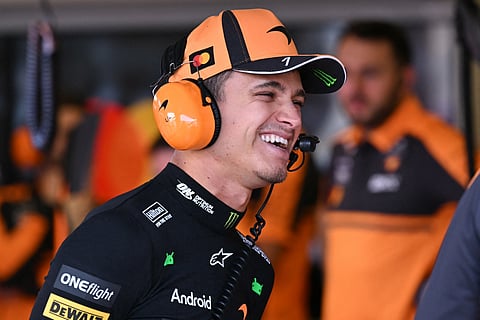 McLaren's British driver Lando Norris wears a headset in the garage ahead of the third practice session of the Formula One Australian Grand Prix at the Albert Park Circuit in Melbourne on March 7, 2026.