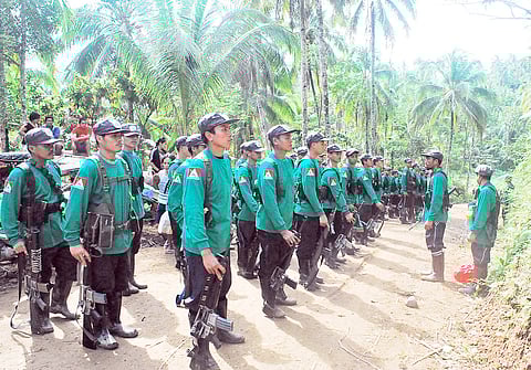 MEMBERS of the New People’s Army form ranks during rites marking the 41st founding anniversary of the Communist Party of the Philippines at an undisclosed location in the hinterlands of Surigao del Sur on 26 December 2009.