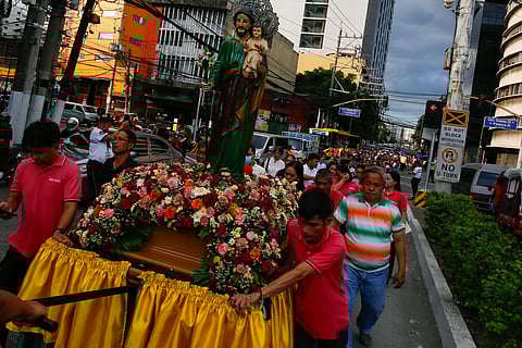 Catholic devotees carry images of St. Joseph in a procession along Ayala Boulevard in Manila this Thursday, 19 March 2026, to celebrate his feast day.