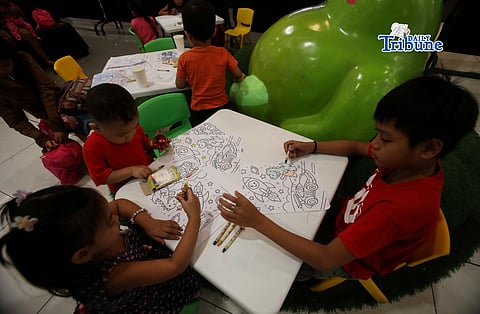 (March 20 2026) Children keep themselves busy use crayons to colour the drawing book, while their mother donating breast milk, during the Quezon City Human Milk Bank’s milk-letting activity, “Gatas ng Buhay: A Life-Saving Collaboration of the Quezon City Human Milk Bank and SM Cares for Women,” held at SM City Fairview in Quezon City on Friday, March 20, 2026. Photo/Analy Labor