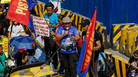 PISTON president Mody Floranda speaks to fellow protesters on Friday morning as they stage a rally calling on the government to provide more subsidies to public utility vehicle drivers.