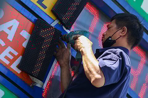 A technician adds a new digit to a fuel price board in Parañaque City on 21 March 2026. The move comes ahead of another anticipated price hike, marking a nearly unbroken streak of increases fueled by the escalating Middle East crisis.