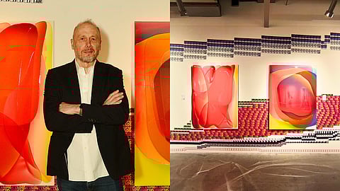 Peter Zimmermann and his epoxy resin paintings, installed atop the sticker mural backdrop.