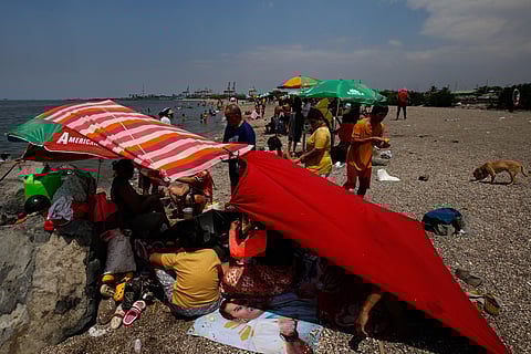 Residents of Baseco, Manila, take a dip at Baseco Beach to beat the heat. State weather bureau PAGASA has announced the end of the Amihan season, signaling the official start of summer.