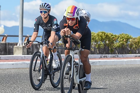 TWO triathletes power along the Davao City Coastal Road in the final stretch of preparation for the BYD IRONMAN 70.3 Davao presented by Aboitiz set to fire off this Sunday. 