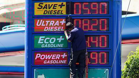 STATION hand adds another digit to a fuel price board in Parañaque City as pump prices continue their near-unbroken climb, driven by escalating tensions in the Middle East.