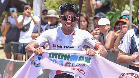 IRIENOLD Reig Jr. celebrates as he crosses the finish line to rule the BYD IRONMAN 70.3 Davao presented by Aboitiz at the Davao Coastal Road on Sunday.