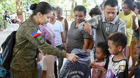 PERSONNEL from the 1st Civil Relations Group, Civil Military Operations Command under the operational control of Northern Luzon Command, hand over bags to children in Barangay Nabuclod, Floridablanca, Pampanga during the Ligang Bayanihan activities.