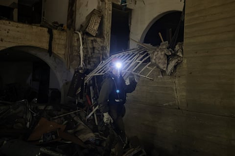 A first responders inspects the site of an Iranian missile strike in Arad early on March 22, 2026. Iranian missile strikes on two southern Israeli towns wounded more than 100 people on March 21, medics said, after Israeli air defence systems failed to intercept the projectiles.

