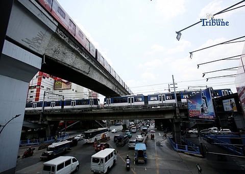 Trains of the Metro Rail Transit Line 3 and Light Rail Transit Line 2 run along tracks in Cubao, Quezon City, 23 March 2026, as a 50 percent fare discount takes effect to help ease the impact of rising fuel prices. The discount applies to all passengers, except those already entitled to reduced fares such as students, senior citizens, and persons with disabilities.  