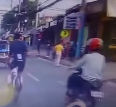SCREEN grab from the hit-and-run incident between a motorcycle rider and an individual on a bike.