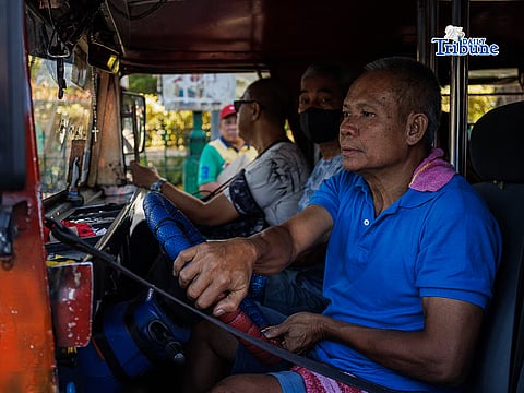 A jeepney driver in Manila City continuing to make ends meet amid ongoing oil price surges.