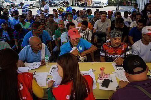 Jeepney drivers line up to receive a P5,000 fuel subsidy at Heroes Park in Manila on Wednesday, 25 March 2026, as part of government efforts to assist transport workers affected by surging oil prices caused by conflict in the Middle East.