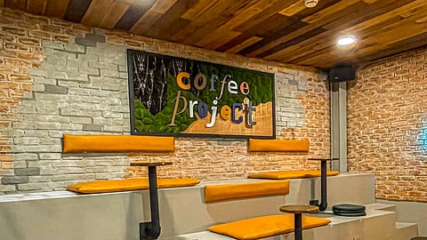 CONCRETE stadium-style seating with orange cushions maximizes vertical space, providing a casual, tiered layout for quick breaks or informal meetings.
