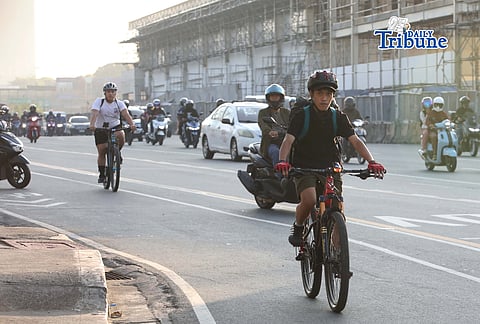 (March 27 2026) Some commuters used bikes passing along Commonwealth Avenue to get to their destinations on Friday morning March 27 2026, on the second day of a transport strike amid rising fuel prices. Photo/Analy Labor 
