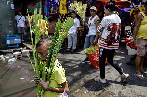 Vendors weave palm fronds into palaspas in Quiapo, Manila, on Saturday, 28 March 2026, ahead of Palm Sunday, which commemorates the successful entry of Jesus Christ into Jerusalem.