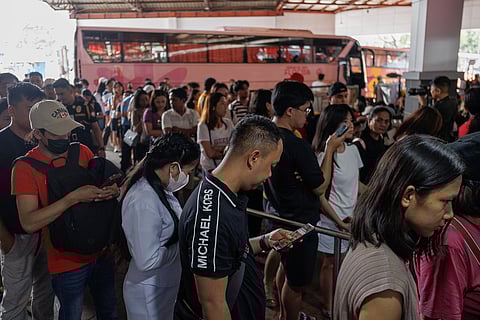 Passengers queue at a bus terminal in Sampaloc, Manila on Sunday, 29 March 2026, as they travel early to their respective provinces ahead of the Holy Week exodus.