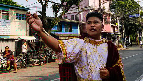 Residents of Barangay 154 in Tayuman, Manila, perform the Sinakulo along Perfecto Street on Holy Monday, March 30, 2026. The Sinakulo is a traditional Philippine dramatic performance that depicts the passion, death, and resurrection of Jesus Christ.
