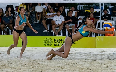 HONEY Grace Cordero of NU dives for the ball as teammate Vilmarie Toos looks on during the finals of the BVR Nuvali Open on Sunday.