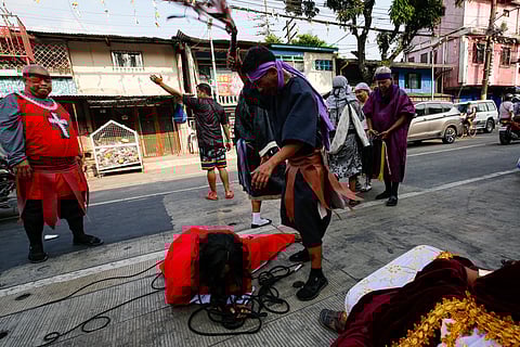 Residents of Barangay 154 in Tayuman, Manila, perform the Sinakulo along Perfecto Street on Holy Monday, March 30, 2026. The Sinakulo is a traditional Philippine dramatic performance that depicts the passion, death, and resurrection of Jesus Christ.