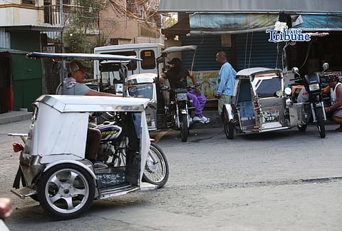 (March 31 2026) Tricycle drivers wait for passengers along a street in North Caloocan on Tuesday March 31 2026. About 30% of tricycle drivers from the CAATTODA in Caloocan City said that they did not receive the P5,000 cash aid for fuel from the government despite their list of names being submitted to the DSWD. Photo/Analy Labor