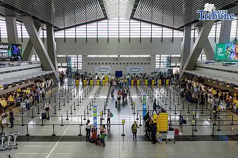 Passengers queue at airline counters at the Ninoy Aquino International Airport Terminal 3, in Pasay City on Tuesday, 31 March 2026. The oil crisis caused by the ongoing war in the Middle East has caused the airfare rates to jump up in price, forcing many Filipinos to ditch going home for the holiday season.

