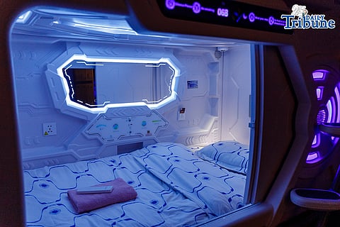 Waiting passengers stay at capsule hotel ahead of their trips for Holy Week