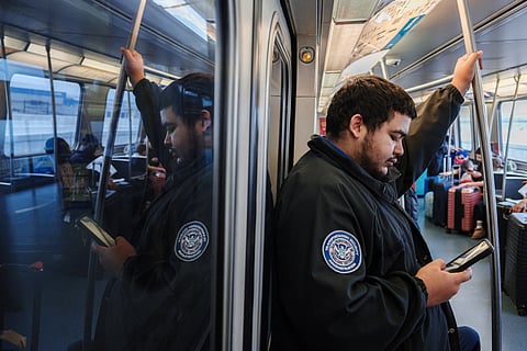 NEW YORK, NEW YORK - MARCH 22: A TSA officer rides the air train at John F. Kennedy International Airport on March 22, 2026 in New York, New York. The travel disruptions continue as hundreds of TSA agents quit or work without pay during a partial government shutdown. U.S. President Donald Trump said ICE agents will be deployed to U.S. airports on Monday, with border czar Tom Homan in charge of the effort. 