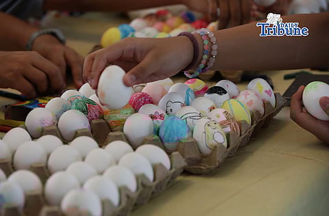 (April 04, 2026) Kids, accompanied by an adult volunteer, paint eggs at the Parish of the Holy Sacrifice at the University of the Philippines Diliman, Quezon City, on Black Saturday, April 4, 2026, as they prepare for their annual Easter Sunday egg hunt activities. Easter Sunday marks the core Christian belief in the Resurrection of Jesus Christ, celebrated as His rising from the dead three days after the Crucifixion. It signifies victory over sin, death, and darkness, offering hope, forgiveness, and eternal life. It ends the Lenten season of reflection, representing new life, renewal, and joy. Photo by Analy Labor
