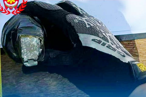 A policeman's hand is seen holding the grenade after it was recovered in the town of San Luis, Aurora on April 1, 2026.