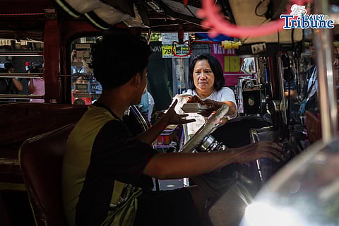 Members of PARA Commuters Network and PISTON Women distribute free lunch meals to jeepney drivers along Agoncillo Street in Ermita, Manila, on Monday, 6 April 2026, during the launch of Kusinang Bayan, a community kitchen initiative aimed at providing solidarity and mutual aid to drivers affected by the oil crisis.