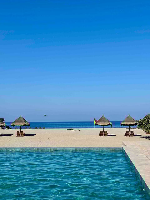 VACATIONERS enjoy a quiet Holy Week break along the shores of Zambales, where clear skies and calm waters offer a welcome escape from the city.