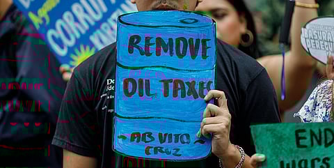 Student activists stage a protest in front of a gas station in Manila, demanding the government to remove oil excise and VAT taxes amid the rising fuel prices caused by the escalating conflict in the Middle East, last Tuesday, 17 March.