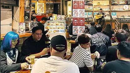 YOUNG vinyl records enthusiasts participate in a listening session.