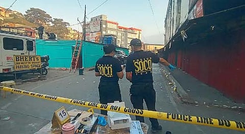 Authorities secure the blast site along Magsaysay Avenue where 14 individuals were injured. A miner was arrested as he was suspected to have caused the explosion using improvised explosives.  