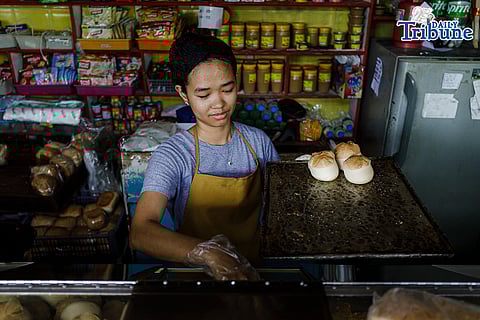Bakers arrange trays of bread for sale at a bakery in Sta. Cruz, Manila, on Monday, 13 April 2026, as the city government is set to distribute a ₱25,000 subsidy to community bakeries to help offset higher input costs and maintain affordable bread for consumers. 