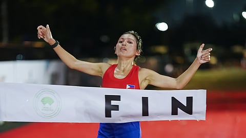 CHRISTINE Hallasgo crosses the finish line to signal her win in the women’s division of the REV Tri-City Half Marathon Time Trial Race on Sunday at the Quirino Grandstand.    