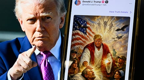 THIS photo illustration created on 13 April 2026 shows a picture of US President Donald Trump on a screen and an AI-generated picture he posted on his Truth Social platform depicting himself as Jesus Christ after criticizing Pope Leo XIV. Trump later posted an AI-generated image seemingly depicting himself as Jesus Christ. 