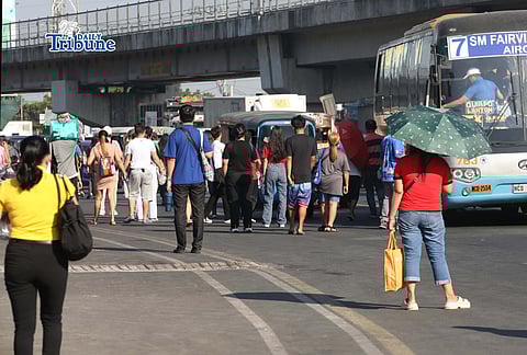 (April 14 2026) Commuters seen waiting for public transport along Commonwealth Avenue in Quezon City, on Tuesday Morning April 14 2026. The Jeepney group is set for a three day transport strike starting April 15-17. Photo/Analy Labor