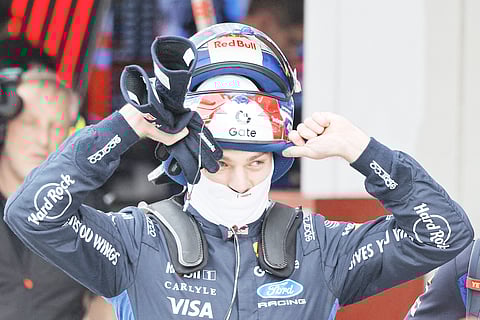 MAX Verstappen removes his helmet in the pits at Suzuka after a qualifying session shaped by ongoing concerns over hybrid engine management.