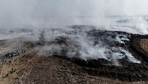 SMOKE scars the skyline as the Navotas landfill continues to smolder days after the blaze began — its toxic haze drifting across Navotas, Malabon and Obando, Bulacan, leaving nearby communities under a cloud of concern.